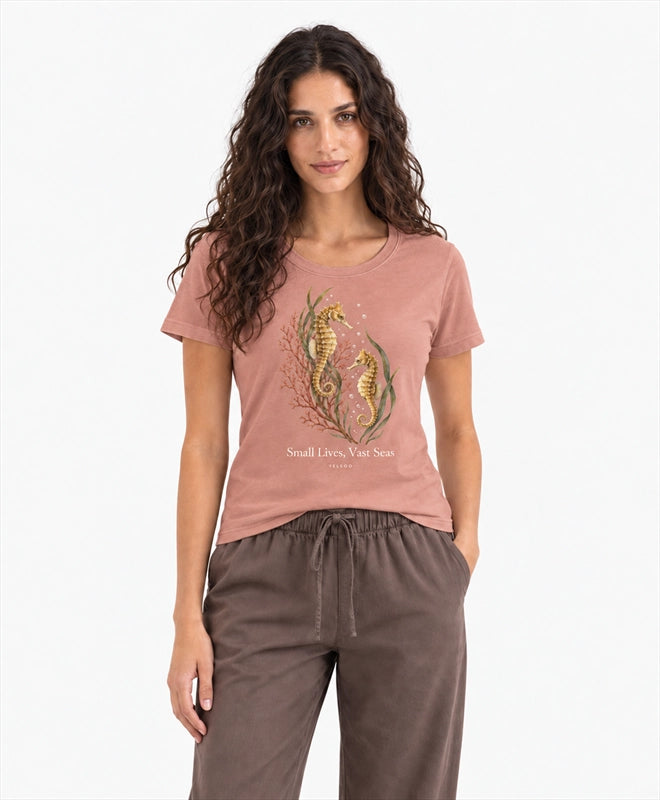 YELSOO women's Small Lives Vast Seas Seahorse Graphic Tee in Misty Coral — front model view