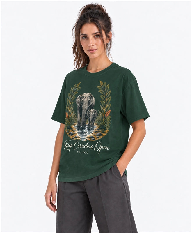 YELSOO men's Big & Tall Keep Corridors Open Asian Elephant Graphic Tee in Forest Green — three-quarter model view