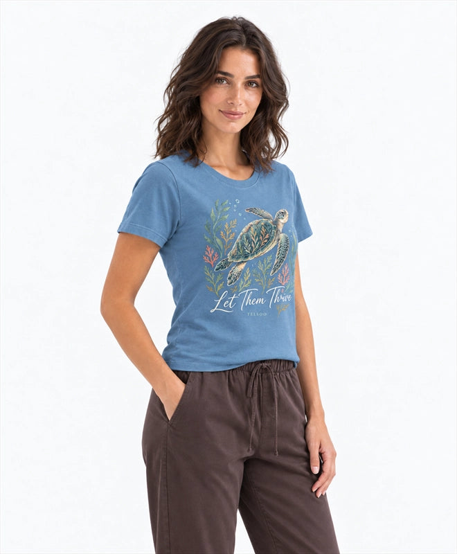 YELSOO women's Let Them Thrive Sea Turtle Graphic Tee in Ocean Blue — three-quarter model view