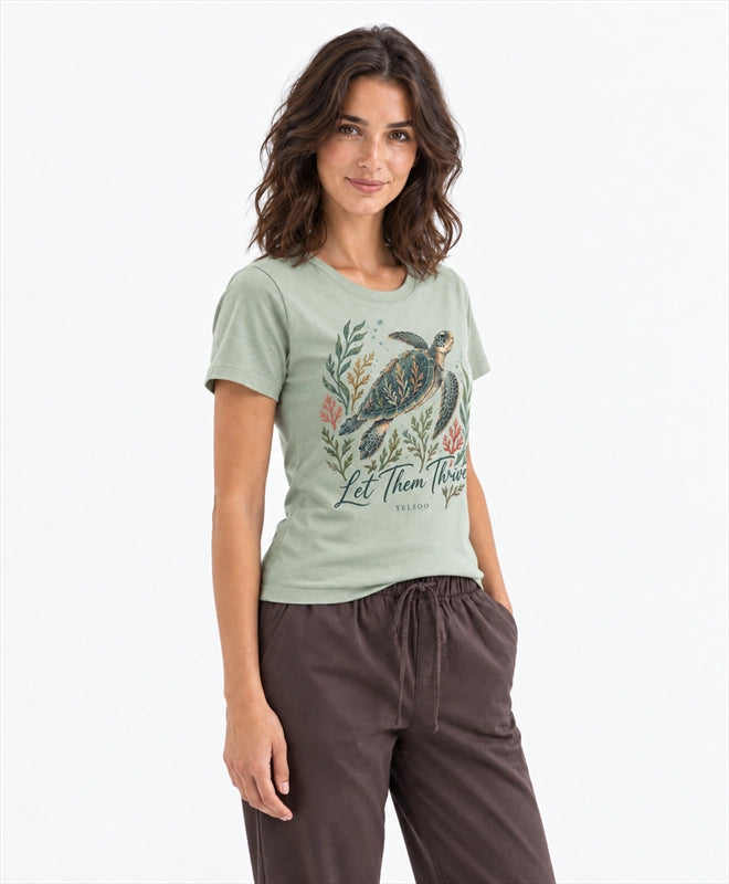 YELSOO women's Let Them Thrive Sea Turtle Graphic Tee in Sage Green — three-quarter model view