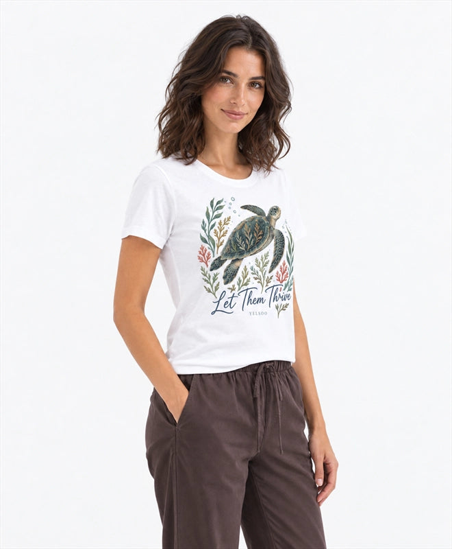 YELSOO women's Let Them Thrive Sea Turtle Graphic Tee in White — three-quarter model view