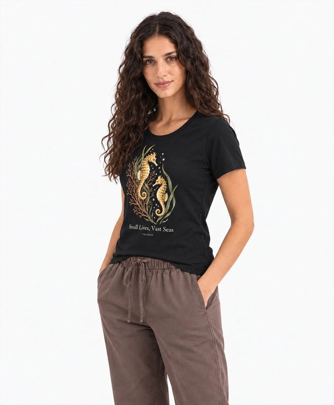 YELSOO women's Small Lives Vast Seas Seahorse Graphic Tee in Black — three-quarter model view