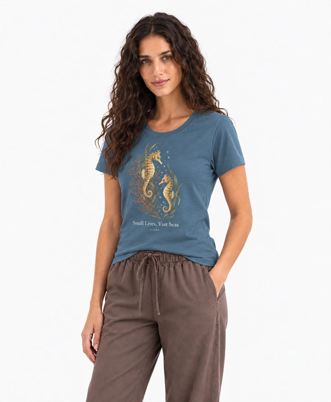 YELSOO women's Small Lives Vast Seas Seahorse Graphic Tee in Deep Sea Blue — three-quarter model view